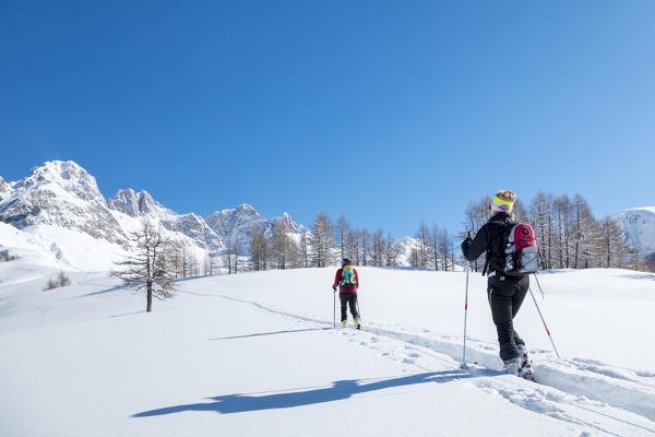 Ski mountaineers uphill towards Forca Rossa, Valfredda, Biois valley, Falcade, Belluno, Veneto, Italy