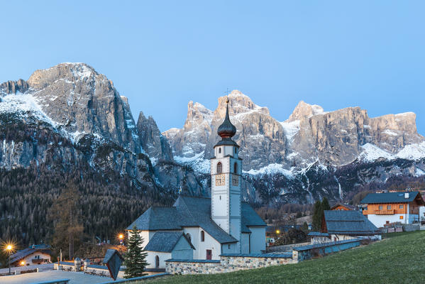 Colfosco, Alta Badia, Dolomites, South Tyrol, Italy. The church San Vigilio with the Sella group in background