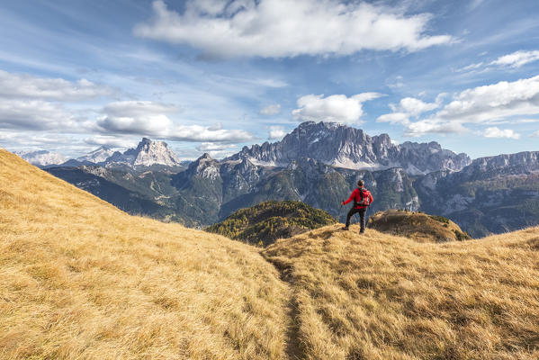 Hiker looking to the Civetta and Pelmo mountains from the path to Sasso Bianco, Agordino, Belluno, Veneto, Italy