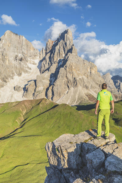 hiker standing admires the Cimon della Pala and Vezzana from a lookout on Castellazzo mountain, Dolomites, Trentino Alto Adige, Trento, Italy