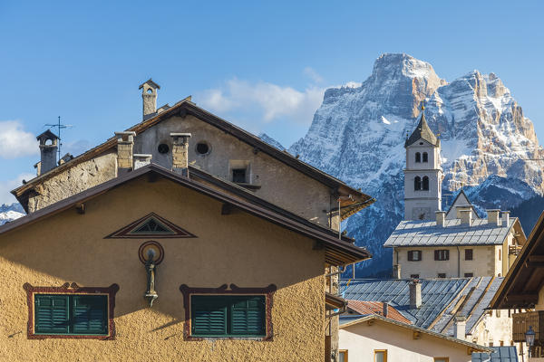 detail of the houses of the village of Colle Santa Lucia, in the background the bell tower of the parish church and behind the mount pelmo, dolomites, agordino, belluno, veneto, Italy