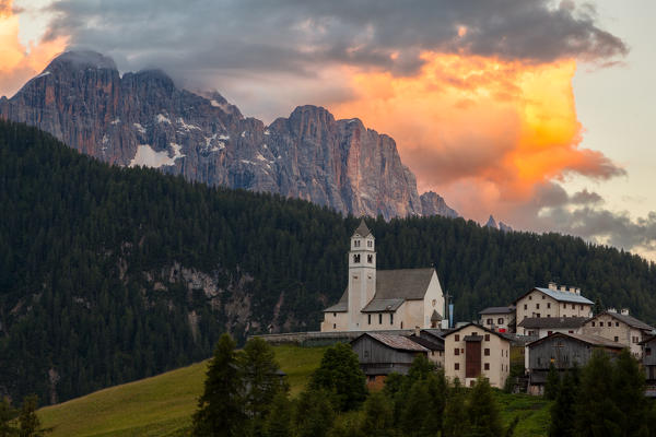 The village of Colle Saint Lucia, in the province of Belluno, perched on a green hill (hence the name) has a beautiful view on two important groups of mountains that form the backdrop: the Pelmo and in the case of this photo the magnificent spiers of the north wall of the Civetta at sunset. Dolomites