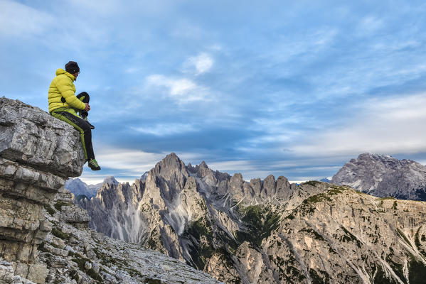 hiker admires the light of sunrise towards the Cadini di Misurina, Auronzo di Cadore, Belluno, Veneto, Italy