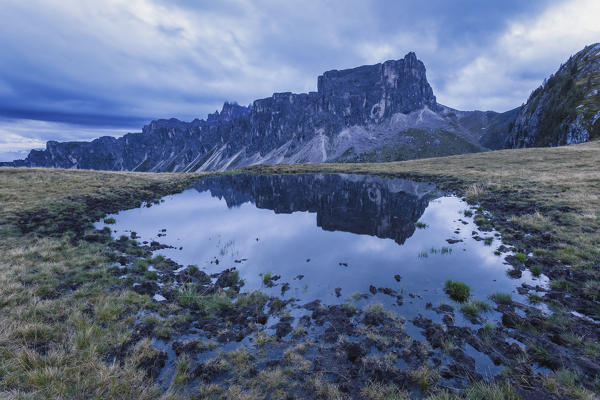 Lastoni di Formin reflected in an alpine pond, Dolomites, San Vito di Cadore, Belluno, Veneto, Italy