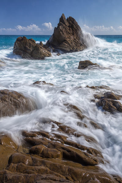 Waves crashing on the rocks of Framura, not far from Deiva Marina in one afternoon in early summer, Liguria, La Spezia, Italy