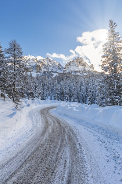 snowy road near Misurina, in the background the Cadini di Misurina. Auronzo di Cadore, belluno, veneto, italy