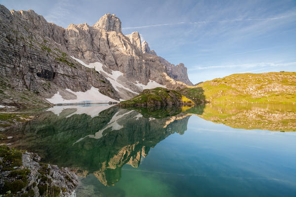 Europe, Italy, Veneto, Belluno. The towers of mount Civetta reflected in the Lake Coldai on a clear summer morning, Civetta group, Dolomites