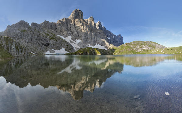 Europe, Italy, Veneto, Belluno. The towers of mount Civetta reflected in the Lake Coldai on a clear summer morning, Civetta group, Dolomites