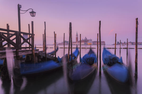 Europe, Italy, Venice. The island of St. Giorgio Maggiore with the gondolas in the foreground
