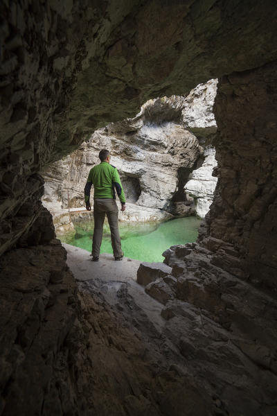 Dolomites, Belluno, Veneto, Italy. Man exploring the gorge of the Soffia waterfall, Mis valley