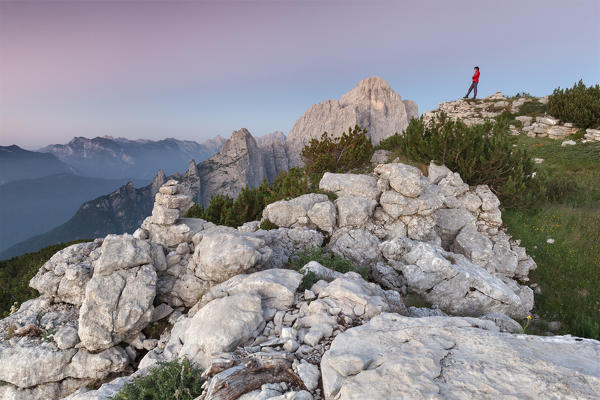 Europe, Italy, Veneto. Hikers on the First Pala di San Lucano summit  looking the sunrise. Agordo Dolomites, Belluno, Italy