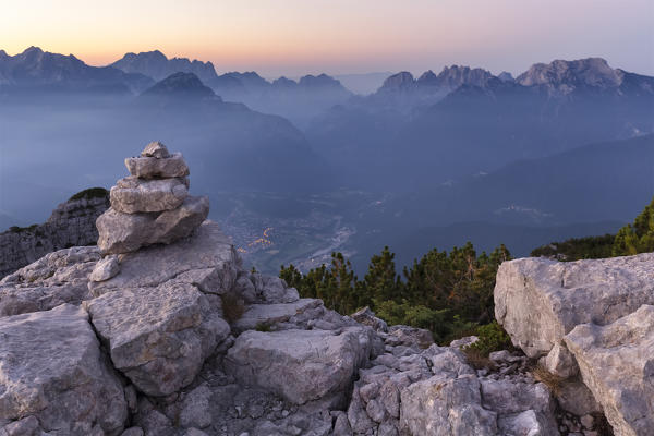 Europe, Italy, Veneto, Belluno. Sunrise from the First Pala di San Lucano summit towards Agordo. Agordino, Dolomites