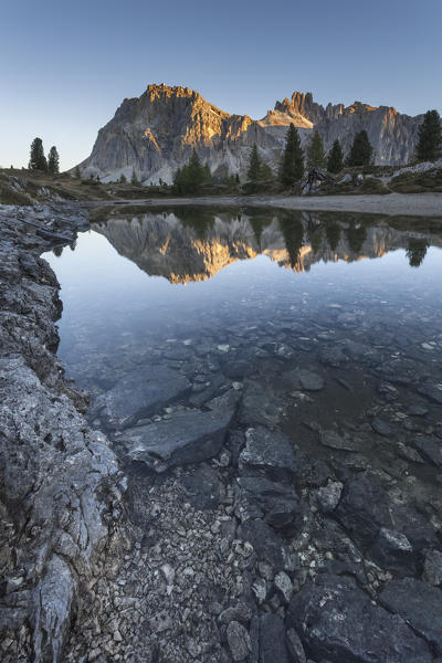 Europe, Italy, Veneto, Belluno. Autumn view on the Limedes alpine lake with the Lagazuoi and Fanis walls reflected, Dolomites