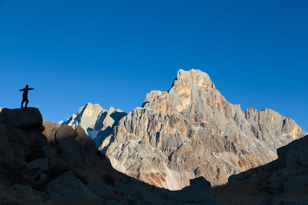 Europe, Italy, Trentino Alto Adige, Cavallazza Piccola. Silhouette of an hiker looking the Cimon della Pala, Pale di San Martino, Dolomites