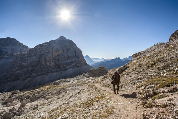 Europe, Italy, Veneto, Belluno, Cortina d Ampezzo. Hiker along the path near Travenanzes fork, in face of Tofana di Rozes, Dolomites