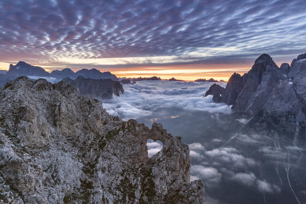 The heart shaped arch of stone in the Pale of the Balconies, Pala group, Dolomites. Europe, Italy, Veneto, Agordino, Belluno