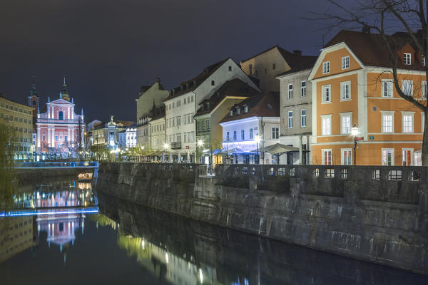 Europe, Slovenia, Ljubljana. Buildings on the Ljubljanica river, on the background the Franciscan Church of the Annunciation