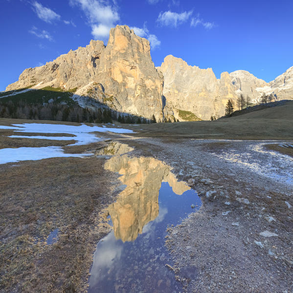 Europe, Italy, Veneto, Belluno, Agordino, Dolomites. Civetta and Moiazza mountains reflected in a water pond at sunset