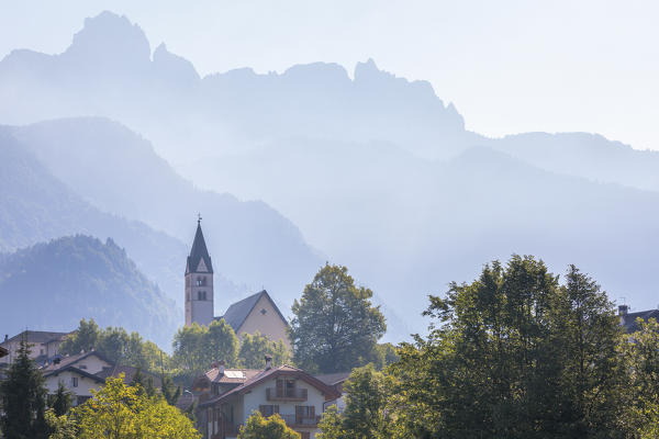 Europe, Italy, veneto, Belluno. La Valle Agordina with the main church and Tamer Moschesin mountains in the background