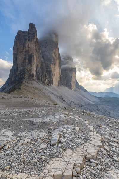 Sunset with clouds on Tre Cime di Lavaredo as seen from Lavaredo fork, Sexten Dolomites, Italy