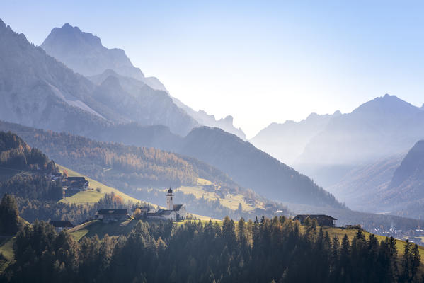 The village of Corte / Curt and the valley of Marebbe / Enneberg with the Fanes Sennes nature park mountains on the background, Bolzano, Alto Adige, Südtirol, Italy