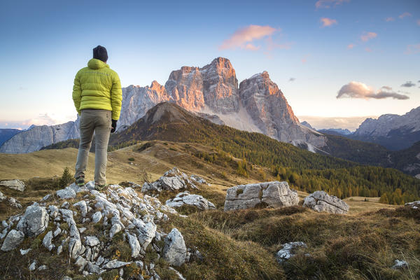hiker on the alpine pasture of Alpe Prendera facing the north-west wall of the mount Pelmo, Col Roan, Dolomites, Borca di Cadore, Belluno, Veneto, Italy