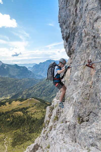 Europe, Italy, Veneto, Agordino, mountain climber on the via ferrata Stella Alpina at mount Agner, Pale di San Martino, Dolomites