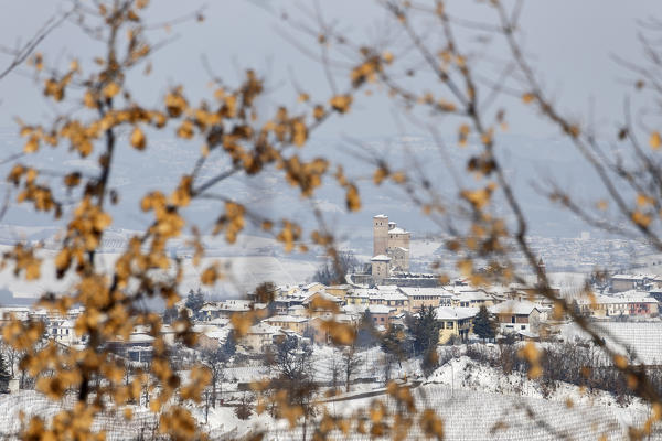 Langhe, Cuneo district, Piedmont, Italy. Langhe wine region winter snow, Serralunga d’Alba castle

