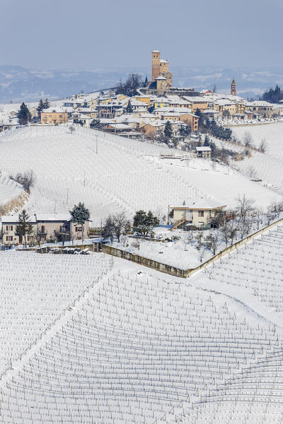 Langhe, Cuneo district, Piedmont, Italy. Langhe wine region winter snow, Serralunga d’Alba castle
