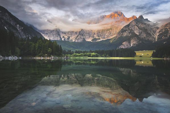 Superior Fusine Lake with Mount Mangart on the background. Fusine Lakes Natural Park, Tarvisio, Udine province, Friuli Venezia Giulia, Italy.