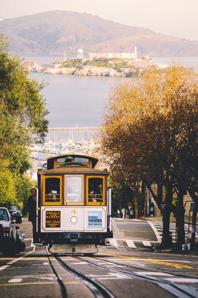 Cable car near Lombard street, with Alcatraz on the background, San Francisco, California, United States Of America
