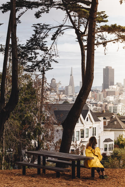 A girl admiring San Francisco financial district from Alamo Square, during autumnal season. San Francisco, California, United States Of America
