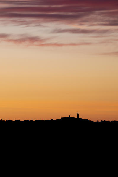 Silhouette of Pienza during sunrise. Pienza, Tuscany, Italy. 