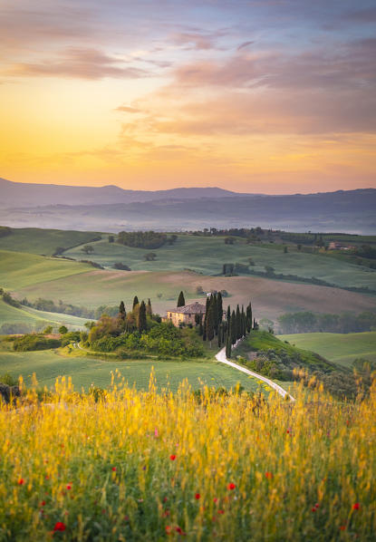 Farmhouse at sunrise near San Quirico d'Orcia, Siena Province, Tuscany, Italy.