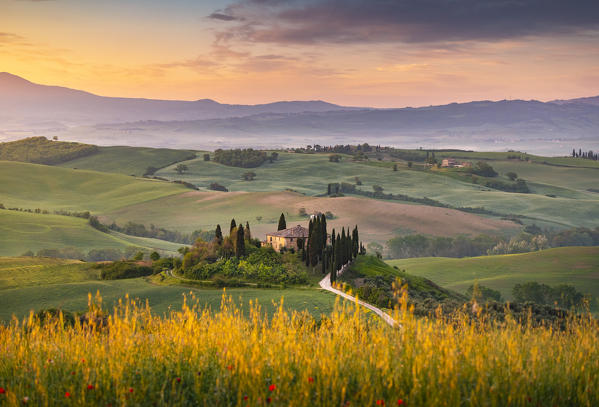 Farmhouse at sunrise near San Quirico d'Orcia, Siena Province, Tuscany, Italy.