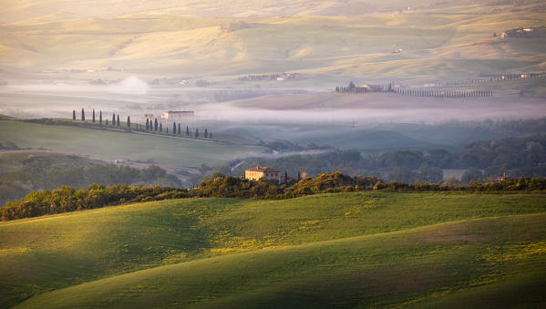 Farmhouse at sunrise near San Quirico d'Orcia, Siena Province, Tuscany, Italy.