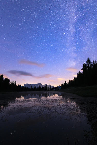Mount Sorapis reflecting itself on Antorno Lake during a night full of stars, near Misurina small village. Misurina, Belluno province, Dolomites, Veneto, Italy