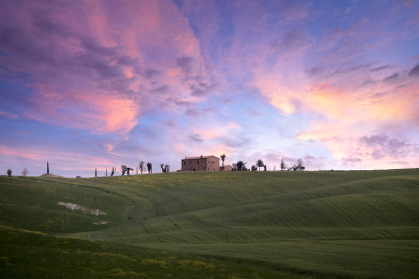 A farmhouse during sunset in Tuscany. San Quirico d'Orcia, Siena PRovince, Tuscany, Italy