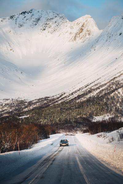 A countryside road covered with snow just near Svolvaer city. Lofoten Islands, Nordland, Norway.