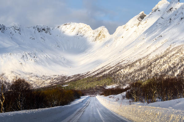 A countryside road covered with snow just near Svolvaer city. Lofoten Islands, Nordland, Norway.