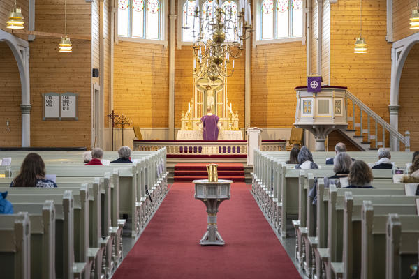 Interior of Leknes Church with celebrating Priest. Leknes, Lofoten Islands, Nordland, Norway.