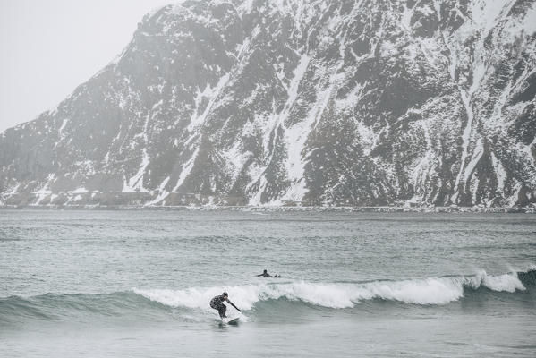 Surfers in Skagsanden Beach, Lofoten Islands, Nordland, Norway.