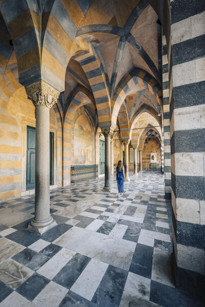 Blonde girl walking in Amalfi cathedral. Amalfi, Amalfi Coast, Sorrento province, Campania, Italy.