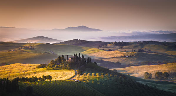 Podere Belvedere, San Quirico d'Orcia, Tuscany, Italy. Sunrise over the farmhouse and the hills. 