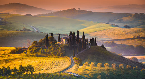 Podere Belvedere, San Quirico d'Orcia, Tuscany, Italy. Sunrise over the farmhouse and the hills. 