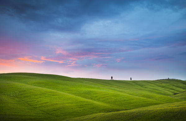 Pienza, Tuscany, Italy. Sunset over the hills and the cypresses.