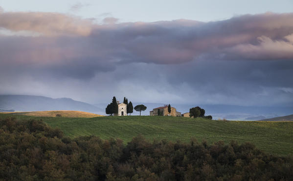 San Quirico d'Orcia, Tuscany, Italy. Sunset over Vitaleta Chapel, with a  very cloudy sky