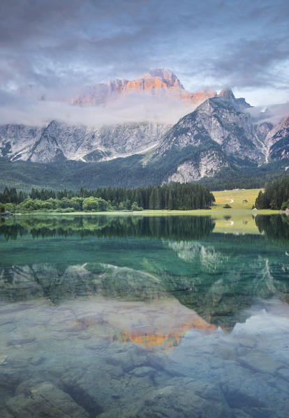 Superior Fusine Lake with Mount Mangart on the background. Fusine Lakes Natural Park, Tarvisio, Udine province, Friuli Venezia Giulia, Italy.