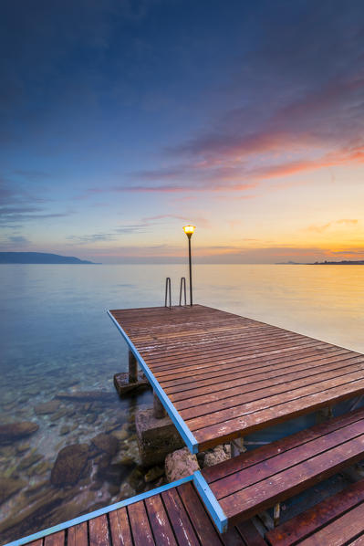 A pier near Toscolano Maderno village, on Garda Lake. Brescia Province, Lombardy, Italy