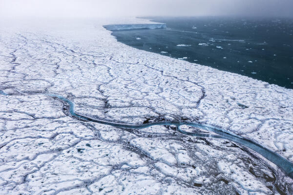 A river flowing on the Austfonna Ice cap in Nordaustlandet, Svalbard, in the Summer.